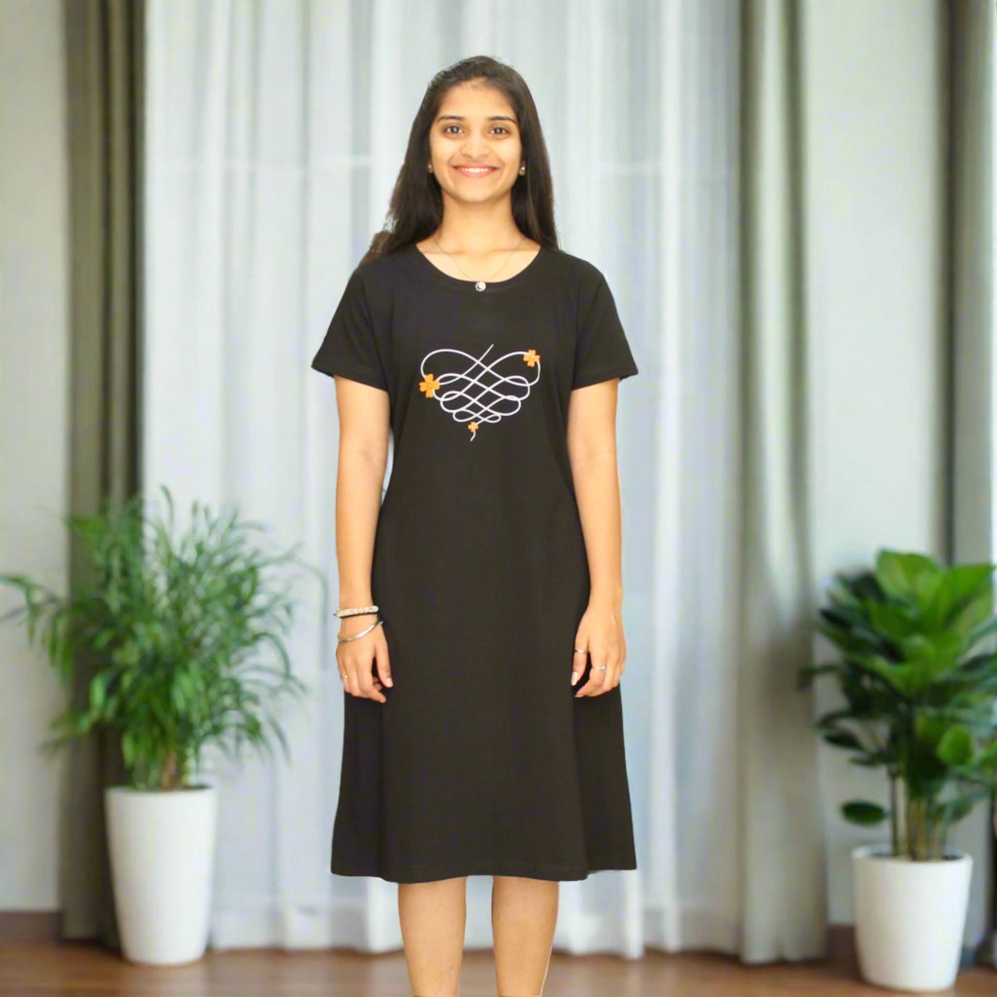 women wearing black cotton knee length short nighty with floral print on chest