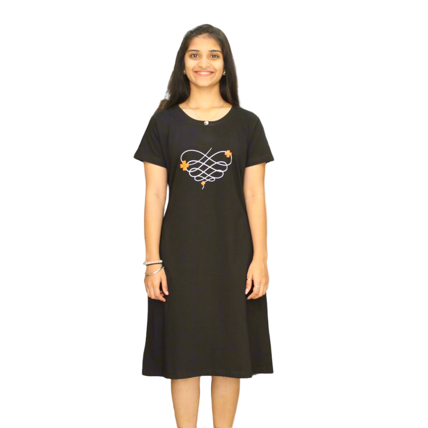 Woman wearing a black dress with a white design on a white background