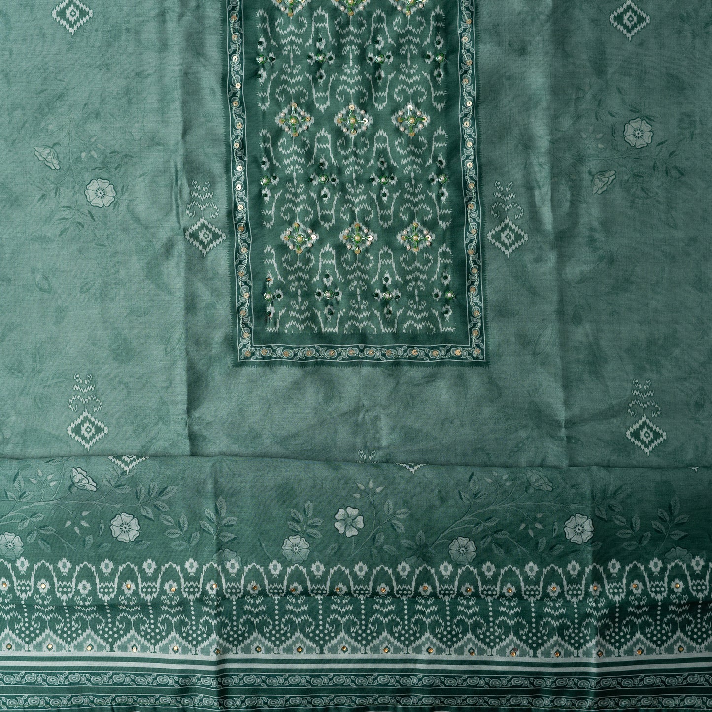 pastel teal color top in silk with floral and patola print all over along with stone work on the yoke