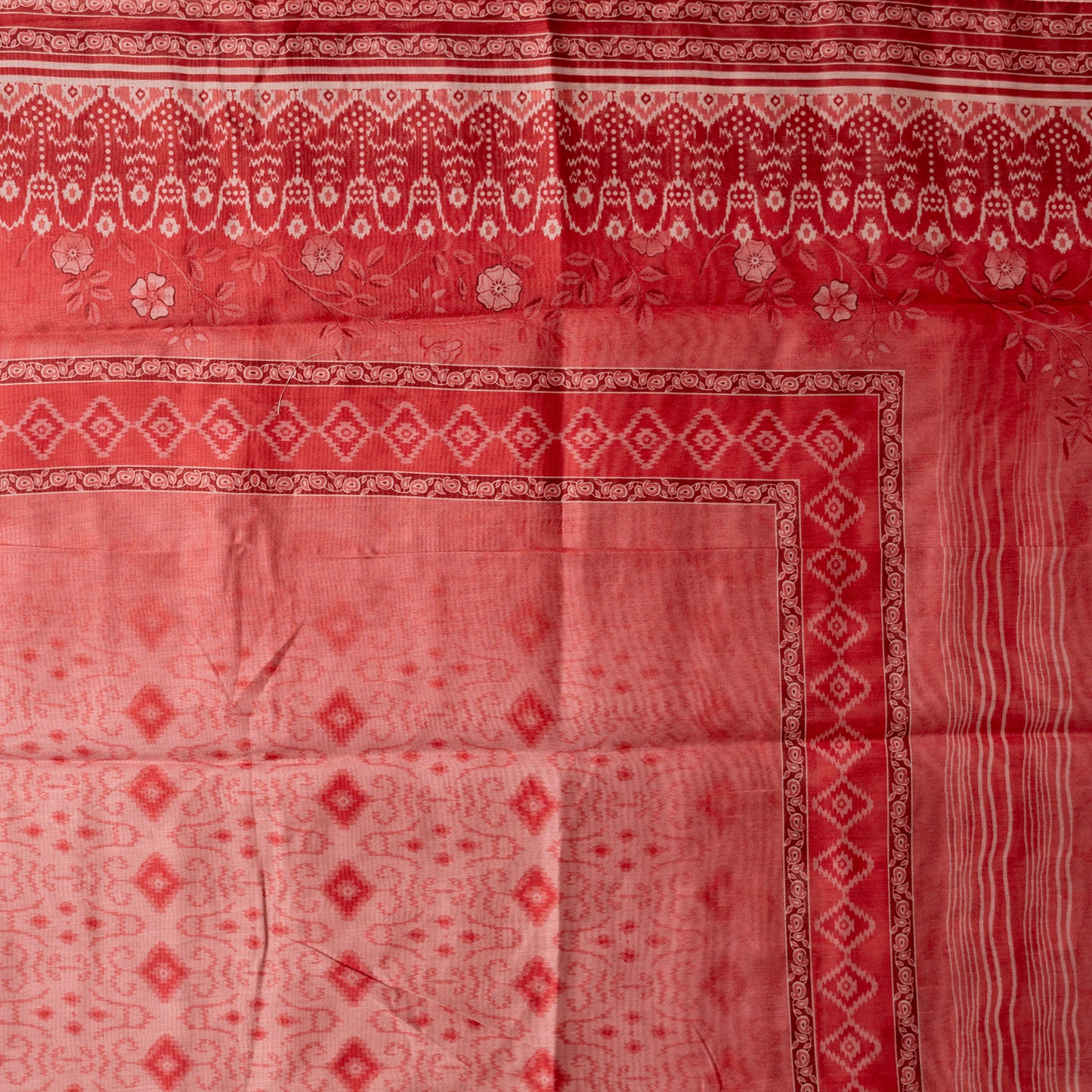 silk dupatta in coral pink color having white based patola prints