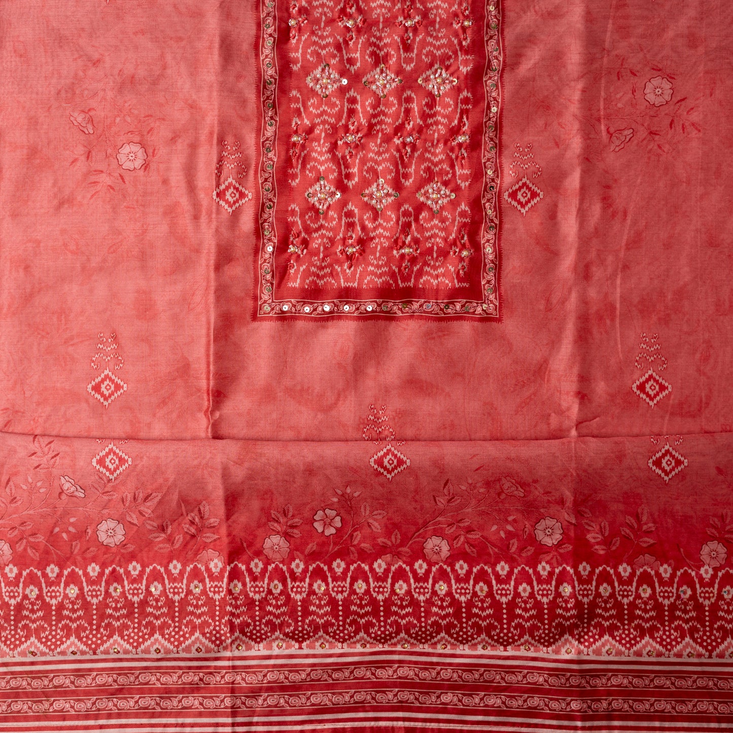 coral pink color silk top with floral and patola prints along with stone work on the yoke