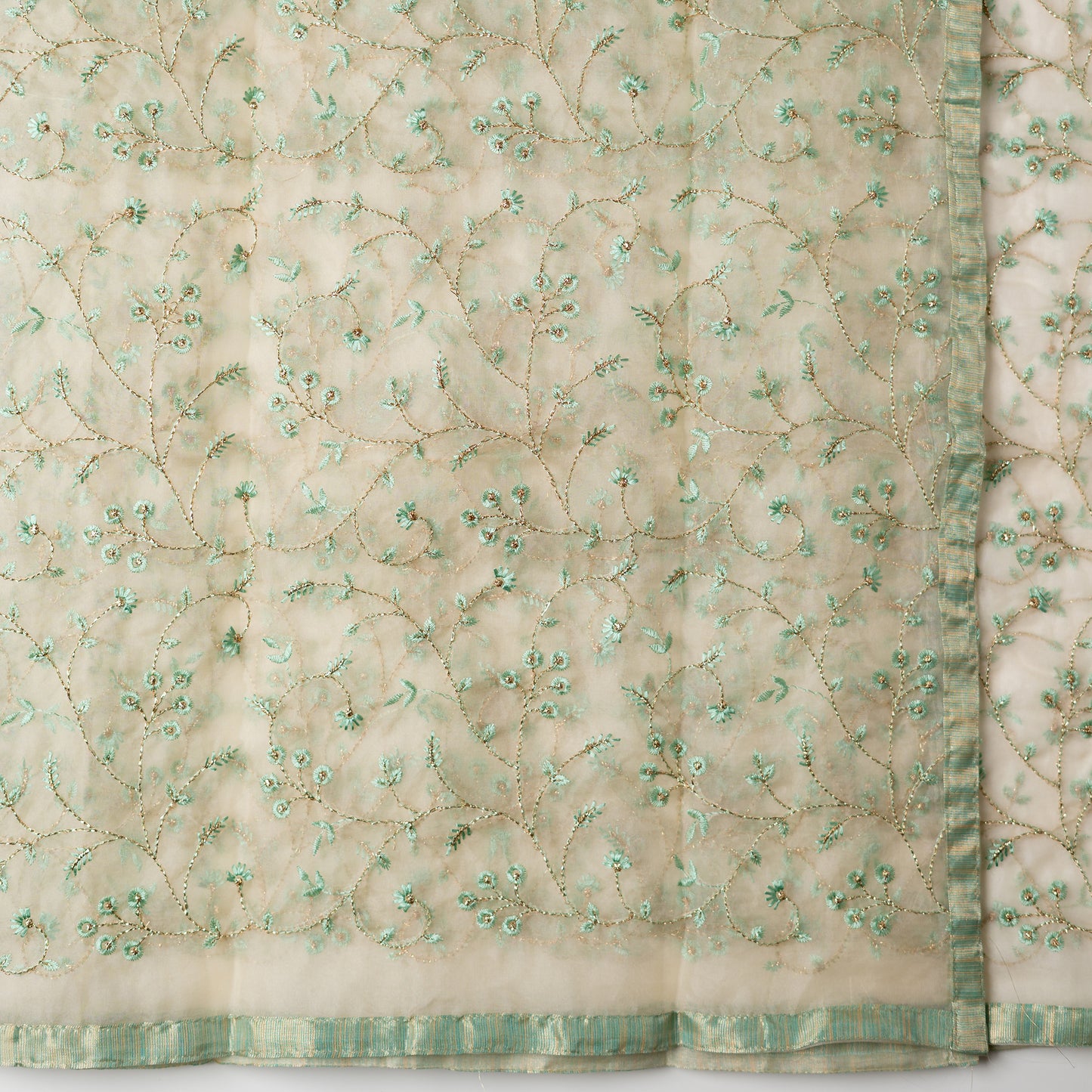 Tissue silk dupatta with embroidery work with the same color thread of top and also golden color threads.