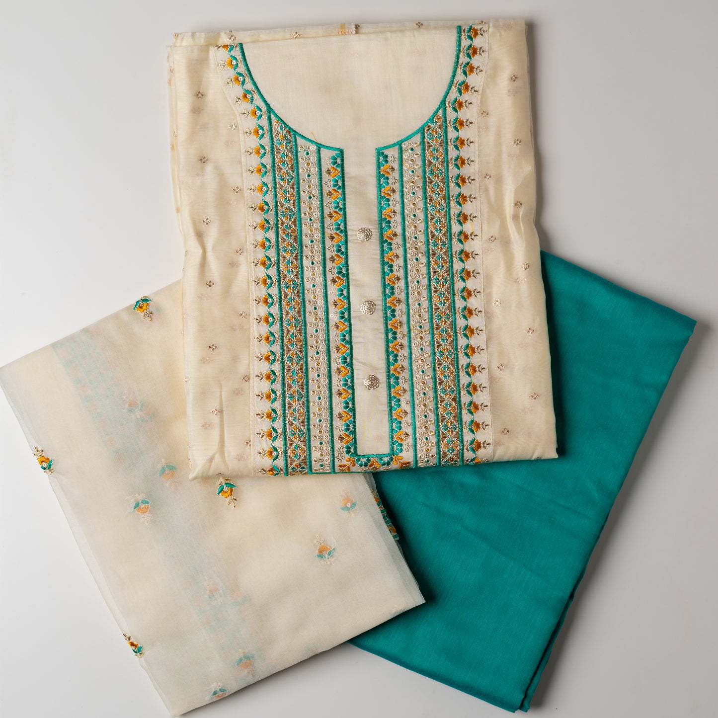 A unique design , perfect for your loved ones . Gift this beautifully embroidered chanderi silk unstitched salwar suit material. Top with embroidery work on neck line and golden thread jacquard small design weaving all over. The border of the dress is also embroidered elegantly. Matching cream color dupatta with embroidery work all over and on the borders. Green color cotton silk bottom.