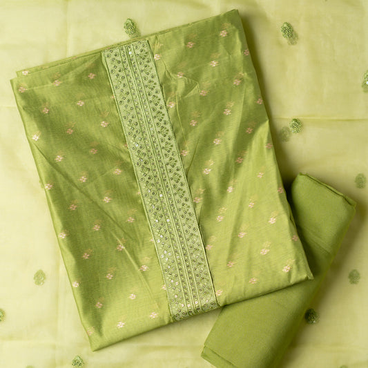parrot green color Beautiful chanderi silk dress material with embroidery and sequins work on neck line. It has jacquard weaving in golden threads all over the top. Tissue silk dupatta with elegant embroidery and sequins work all over dupatta and at the borders. Parrot green color cotton silk bottom  matching the top and dupatta.