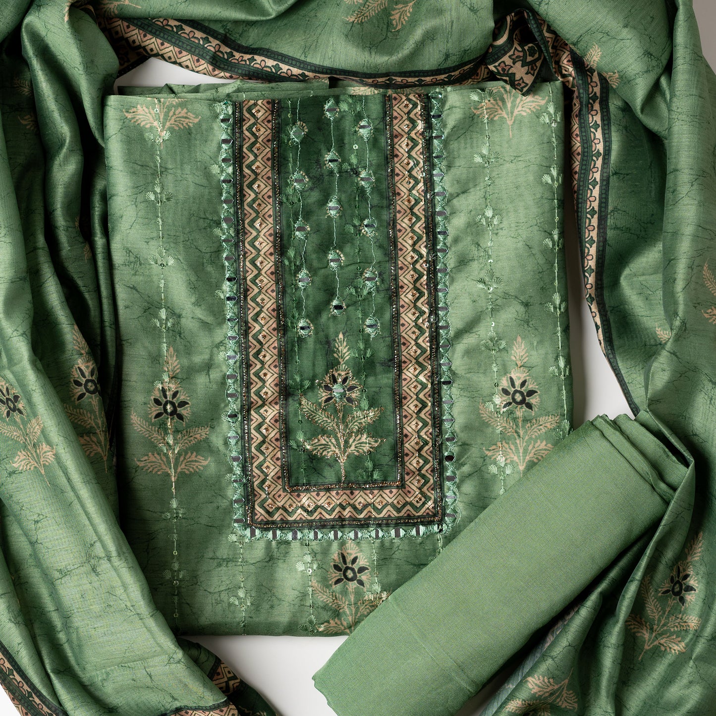 Chanderi silk dress material with print design, embroidery work, thread work and sequins work. It has zari and mirror work in neck area also. Silk dupatta with beautiful digital prints matching the top color. Cotton silk bottom same green color as the top and dupatta.