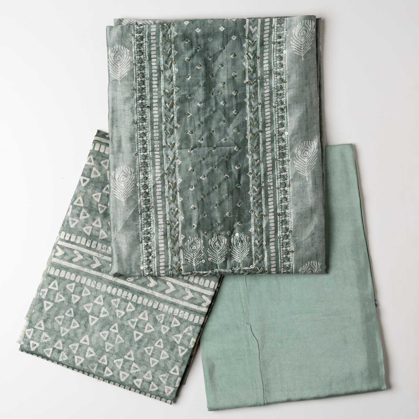 Chanderi silk dress material with thread work and and sequins work, the thread work is done with the same color thread of the top. Digital printed silk dupatta with same color combination as top. Light green color cotton silk bottom, matching the top and dupatta color.