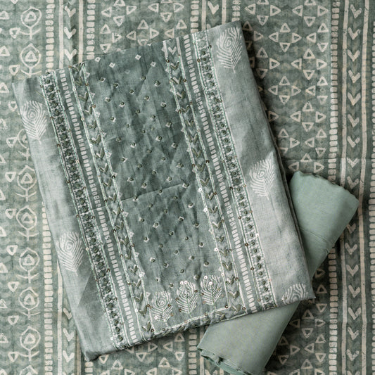 Chanderi silk dress material with thread work and and sequins work, the thread work is done with the same color thread of the top. Digital printed silk dupatta  with same color combination as top. Light green color cotton silk bottom, matching the top and dupatta color.
