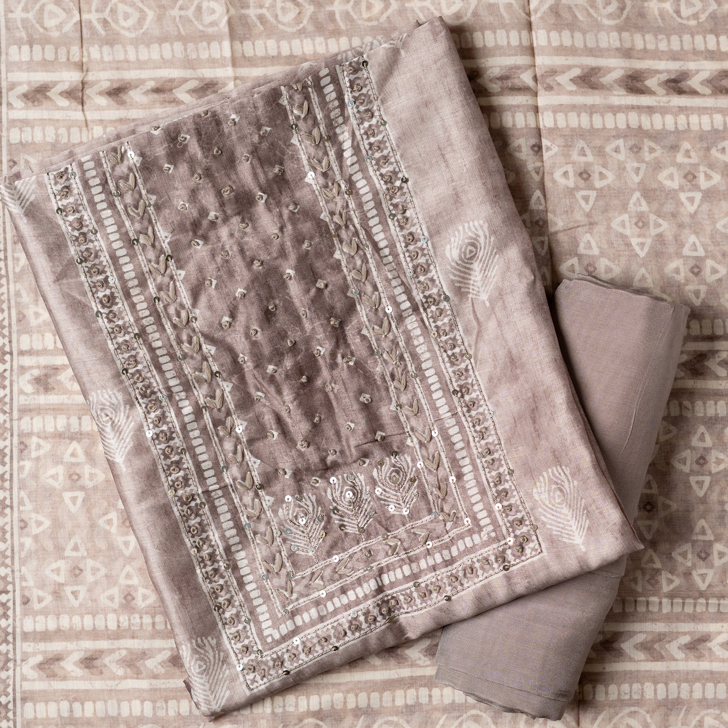 Chanderi silk dress material with thread work and and sequins work, the thread work is done with the same color thread of the top. Digital printed silk dupatta with same color combination as top. Light brown color cotton silk bottom, matching the top and dupatta color.