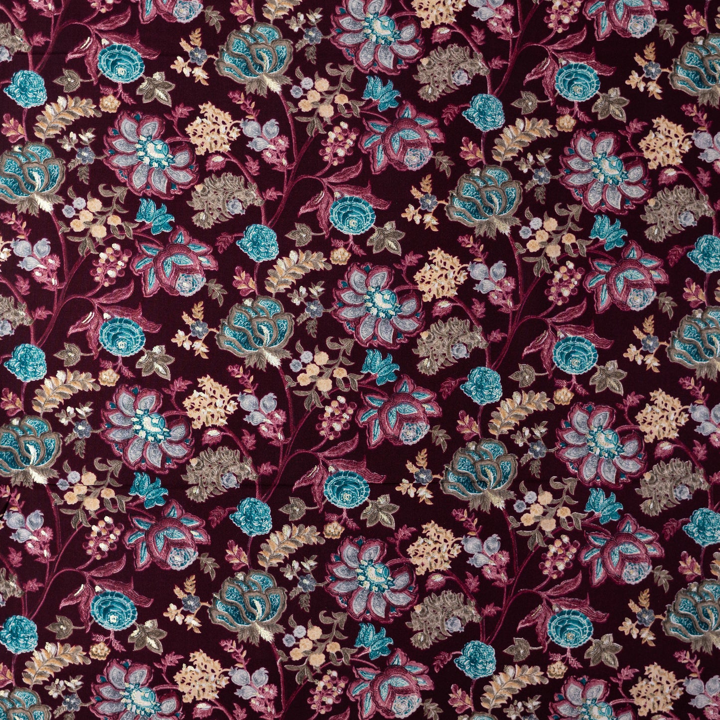 wine red color rayon fabric with gold color print design along with other multi color floral designs