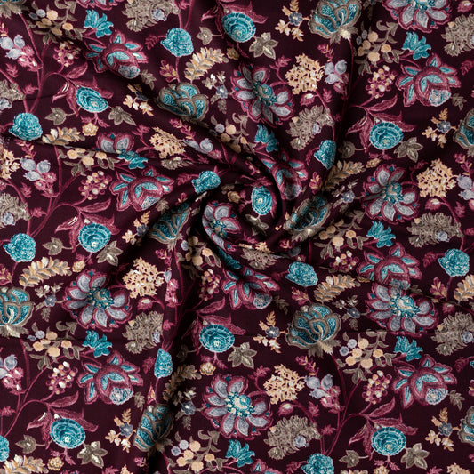 wine red color rayon fabric with gold color print design along with other multi color floral designs