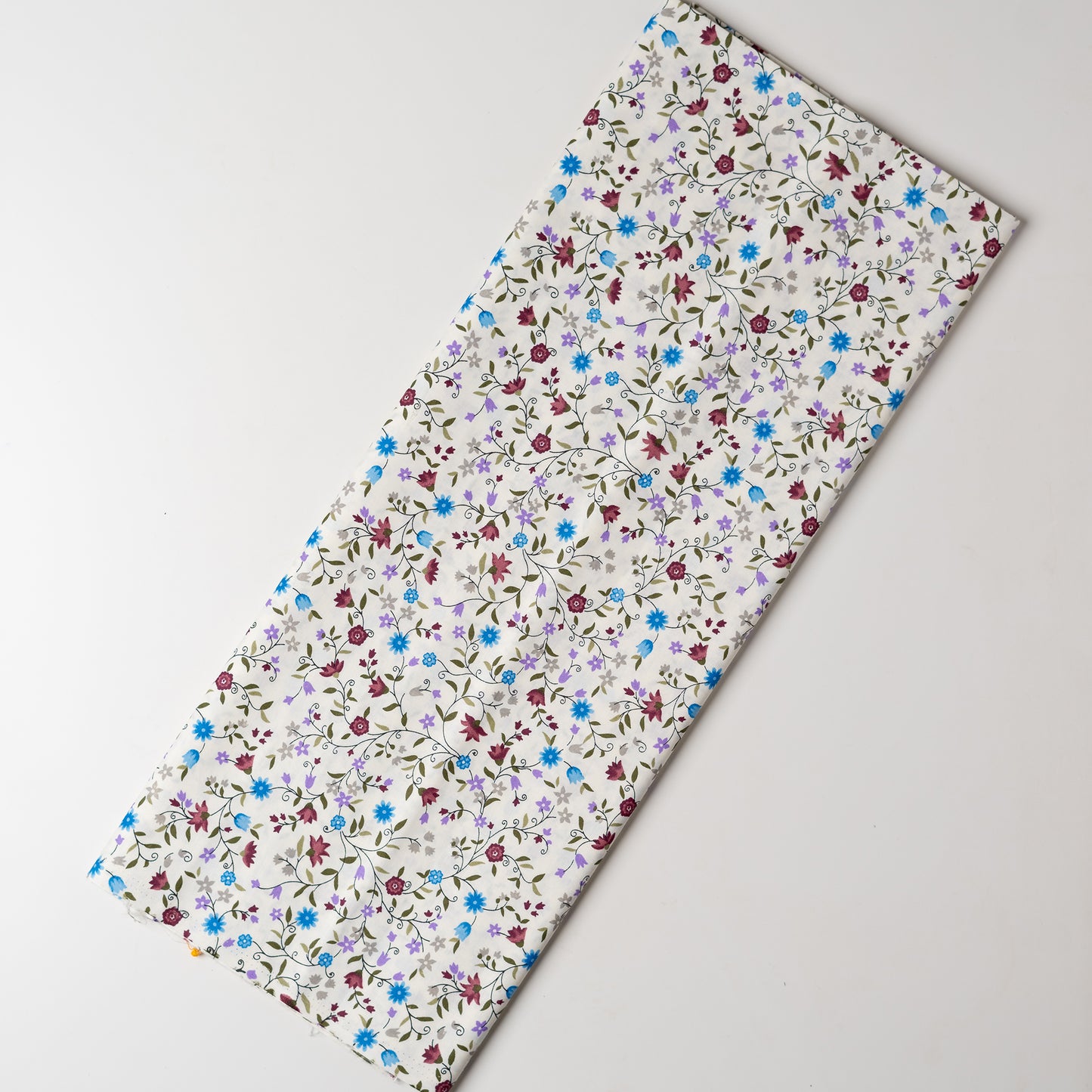 White color fabric with multi color small elegant print design