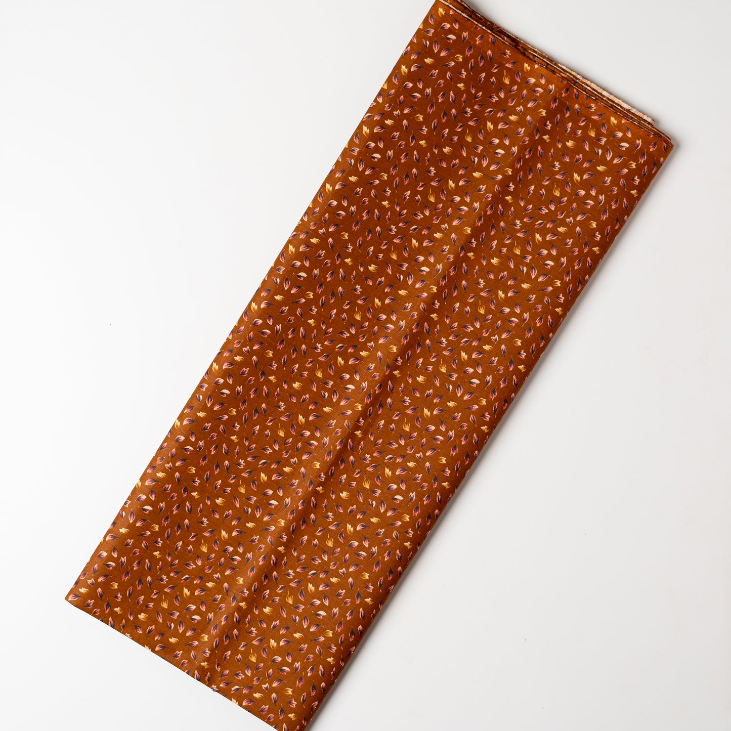 Light brown color fabric with navy blue and cream color beautiful prints .