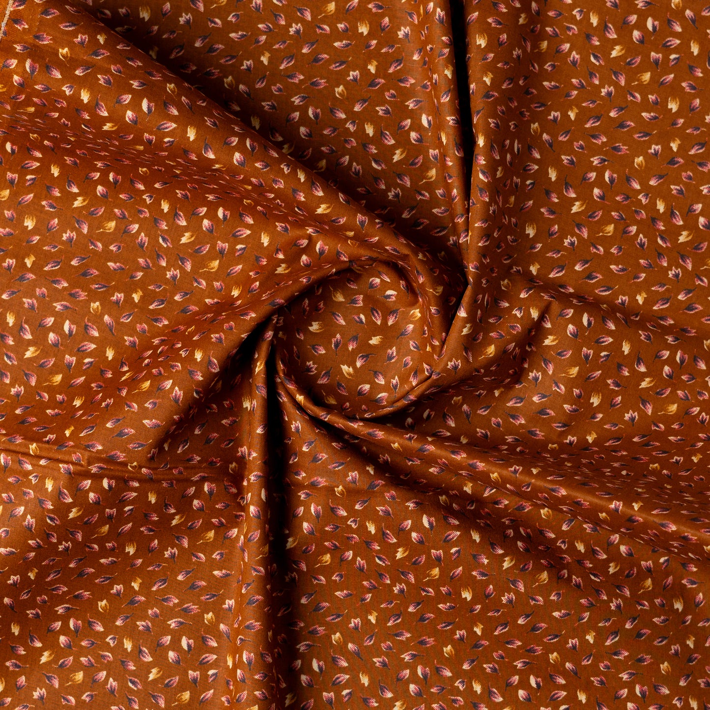 Light brown color fabric with navy blue and cream color beautiful prints .