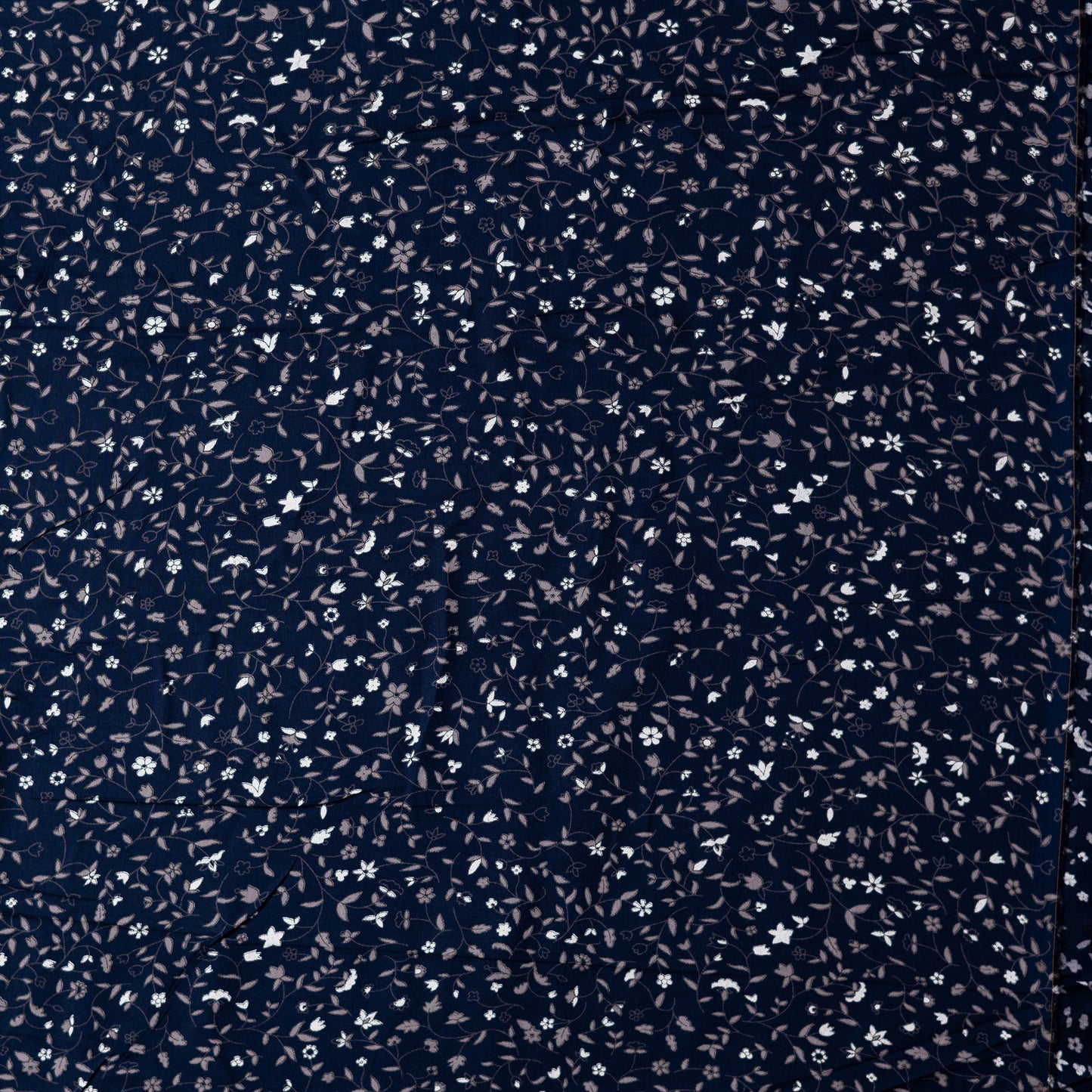 Navy blue color rayon fabric with white and grey color floral prints, this is a small print design elegant fabric