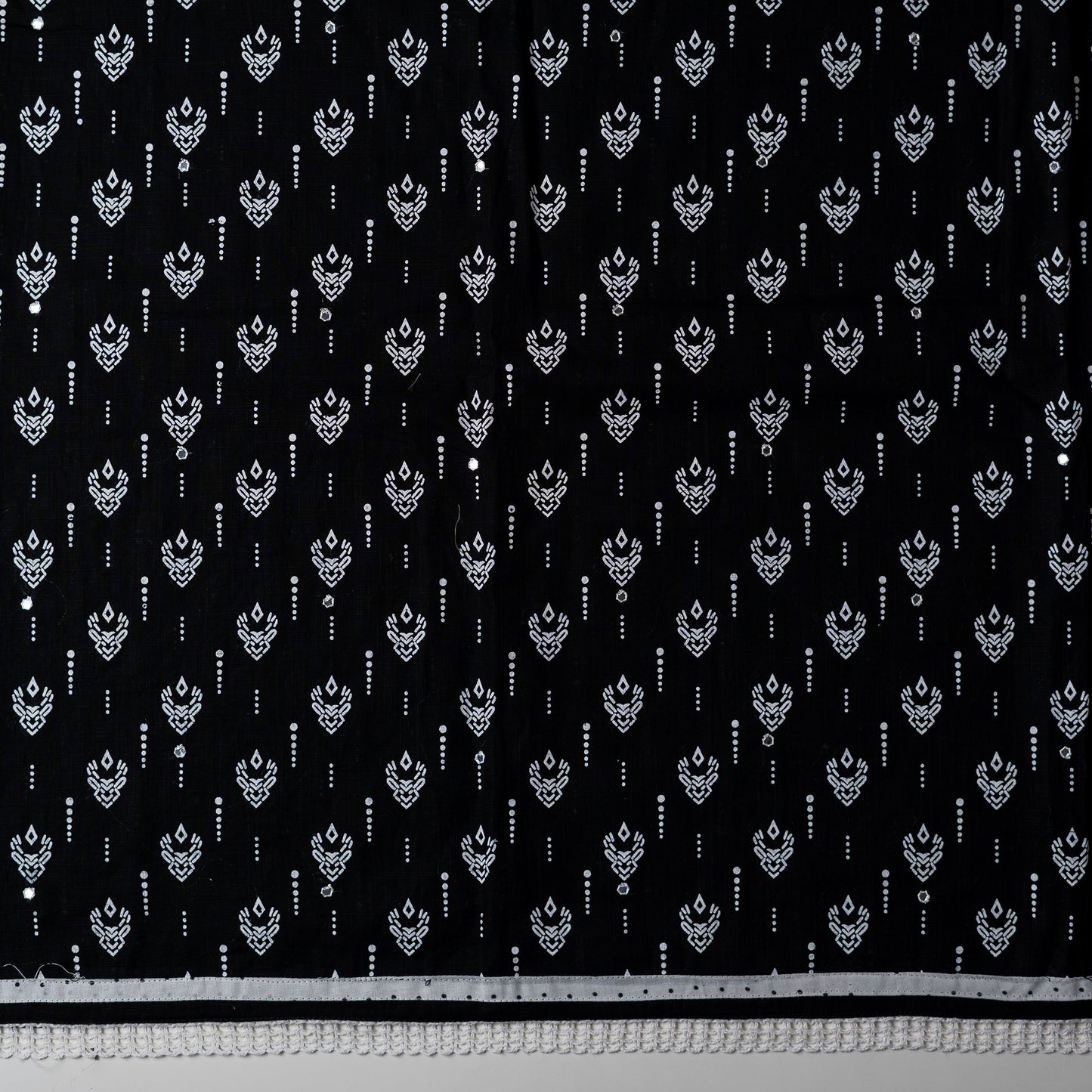 cotton black color top with white color print design and mirror work, it has lace work in the border