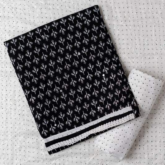 Cotton black color dress material with beautiful print design in white color on top, mirror work. It has white color lace on the borders. Chiffon dupatta with embroidery work in white color and black dotted prints. Cotton white color bottom with black dots.