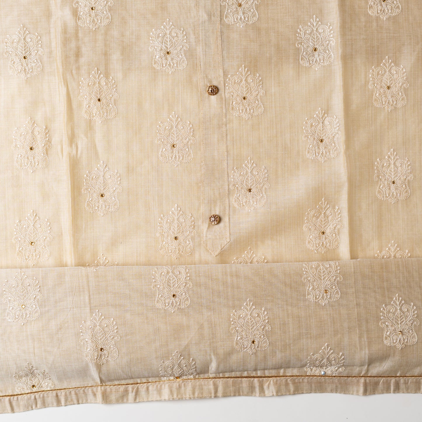 Chanderi silk dress material with embroidery work, the embroidery work is done with the same color thread of the top which gives a very elegant look. The top has show buttons and golden color piping in the border.