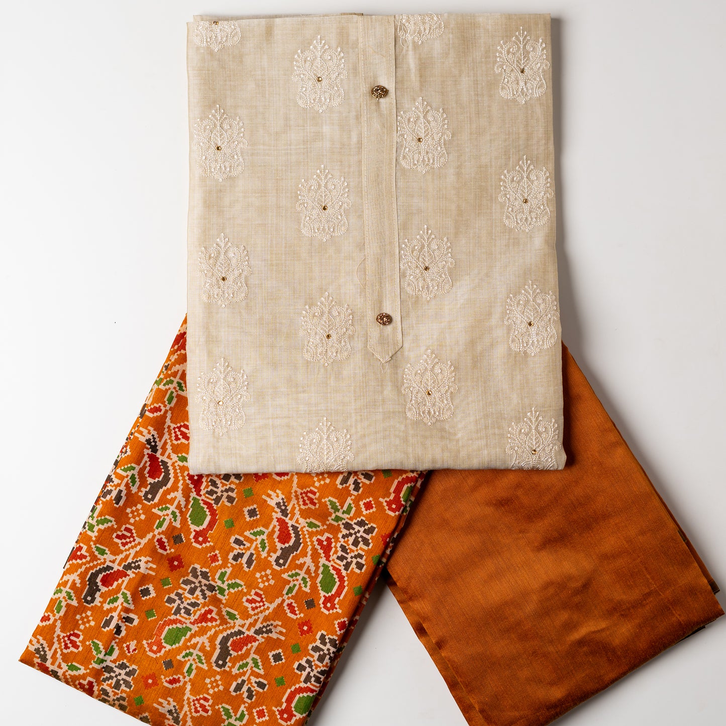 Chanderi silk dress material with embroidery and sequins work, the embroidery work is done with the same color thread of the top which gives a very elegant look. The top has show buttons and golden color piping in the border colorful digital printed silk dupatta , golden brown color cotton silk bottom.