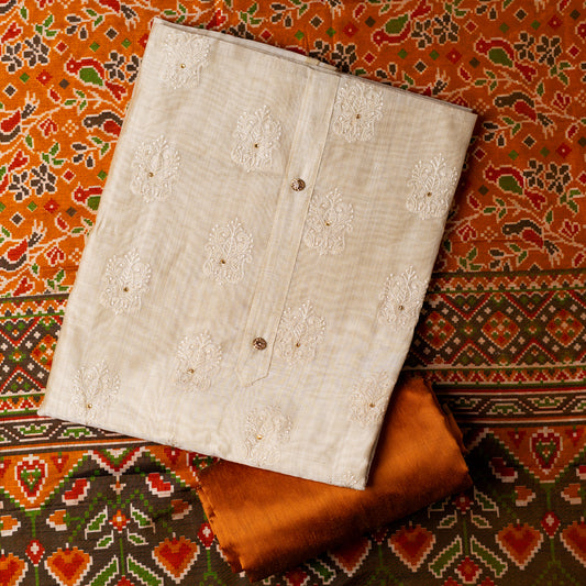 Chanderi silk dress material with embroidery and sequins work, the embroidery work is done with the same color thread of the top which gives a very elegant look. The top has show buttons and golden color piping in the border colorful digital printed silk dupatta , golden brown color cotton silk bottom.
