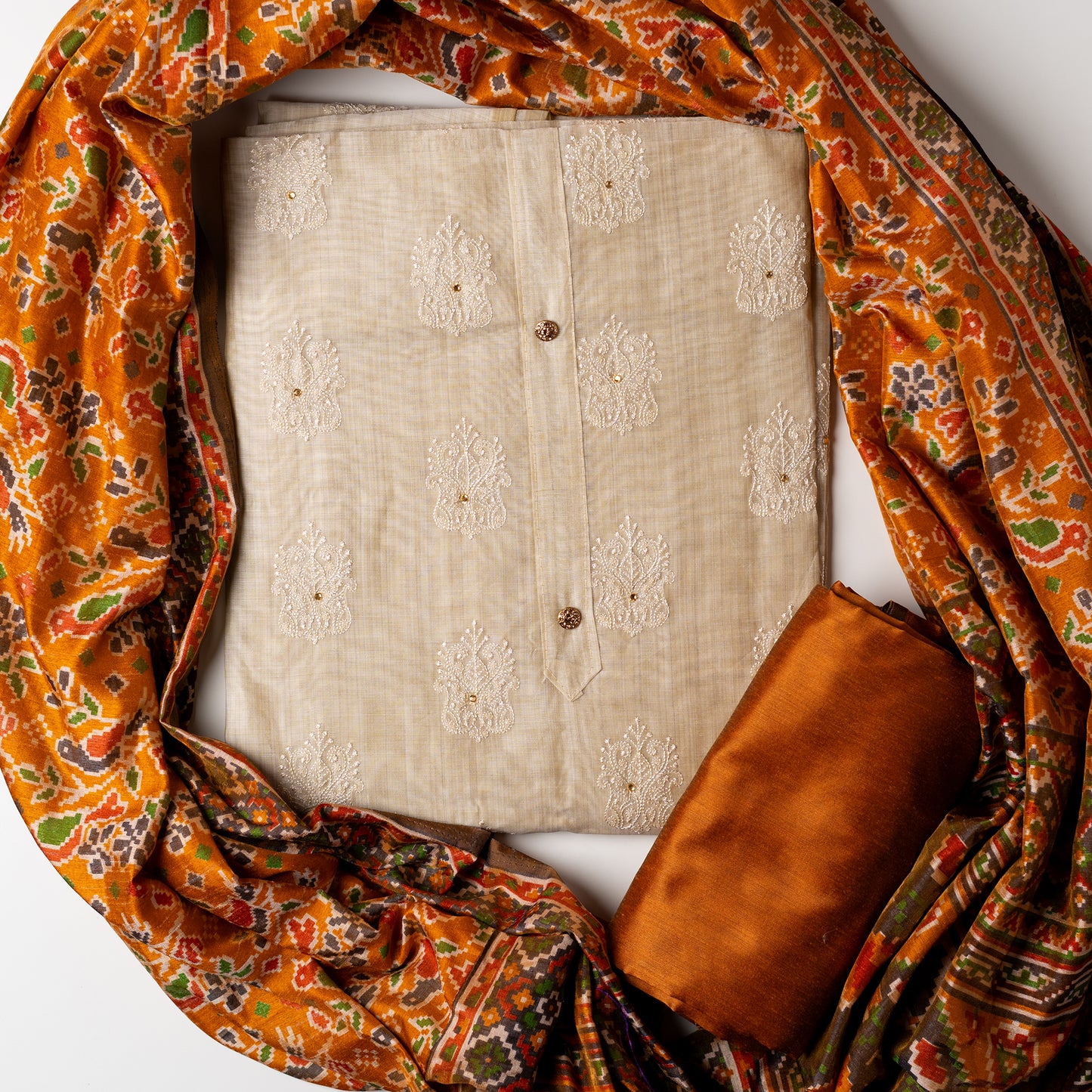 Chanderi silk dress material with embroidery and sequins work, the embroidery work is done with the same color thread of the top which gives a very elegant look. The top has show buttons and golden color piping in the border colorful digital printed silk dupatta , golden brown color cotton silk bottom.