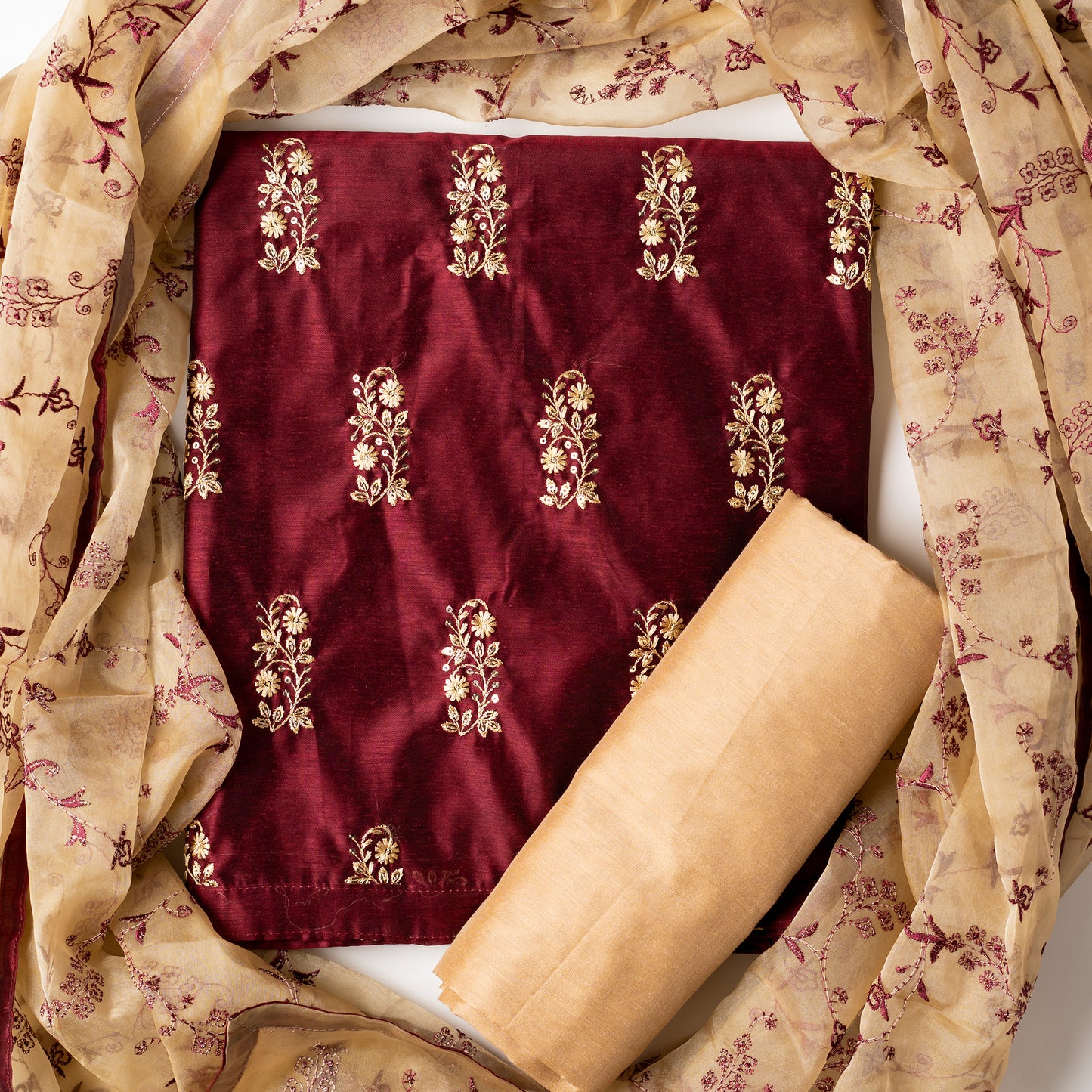 This beautiful chanderi silk dress material set will suit you for any of your functions, be it evening party, bridal wear, birthday party or anniversary gift. Maroon color top with elegent embroidery and sequins work. Cream color silk dupatta with matching maroon color embroidery work is giving the set a perfect party wear look. Cotton silk cream color border.