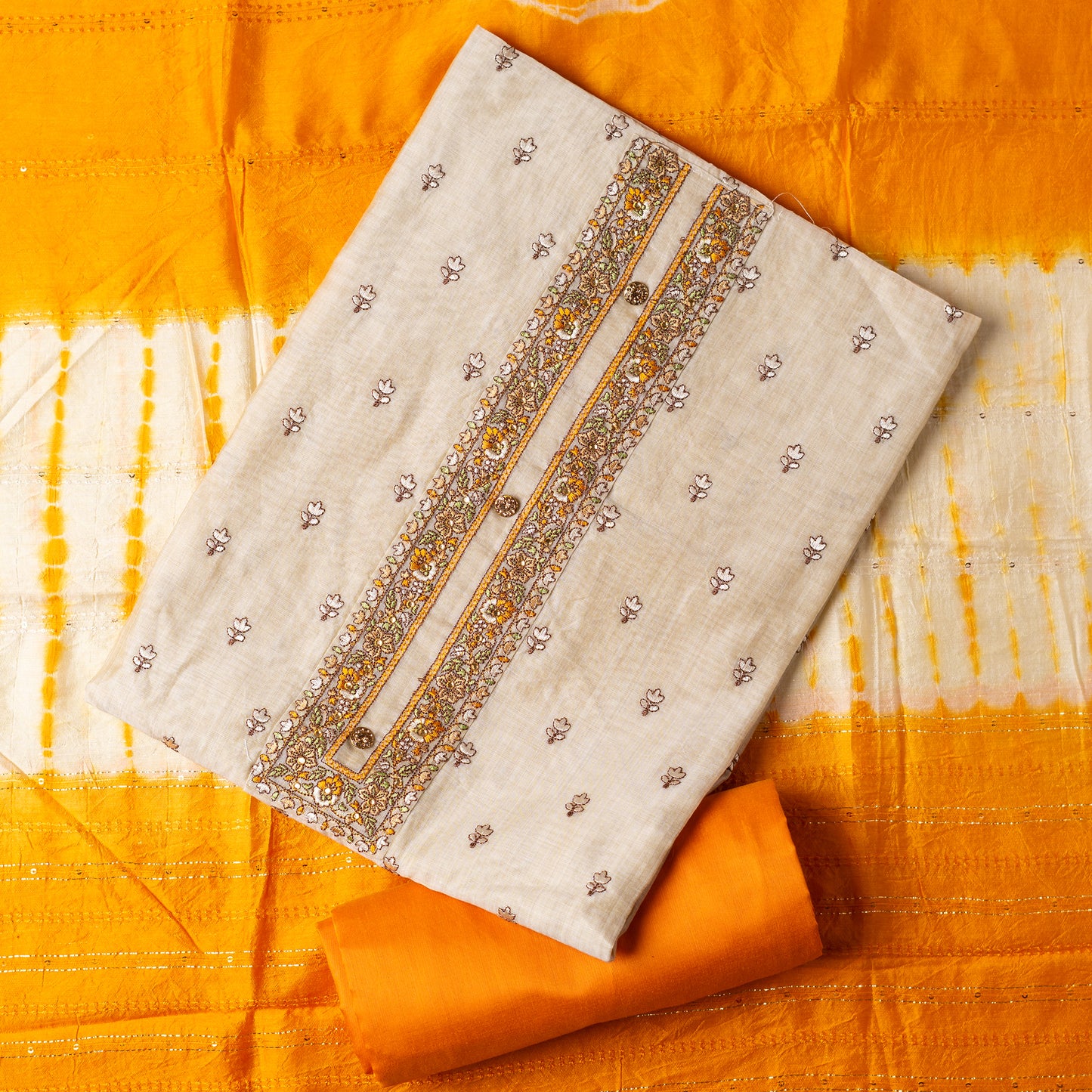 Chanderi Silk Dress material set, Ivory color Chanderi Silk top with floral embroidery all over the body in the front and elegant embroidery work in neck line with show buttons. cotton mustard color plain bottom. Mustard and cream color silk dupatta with sequins and thread work