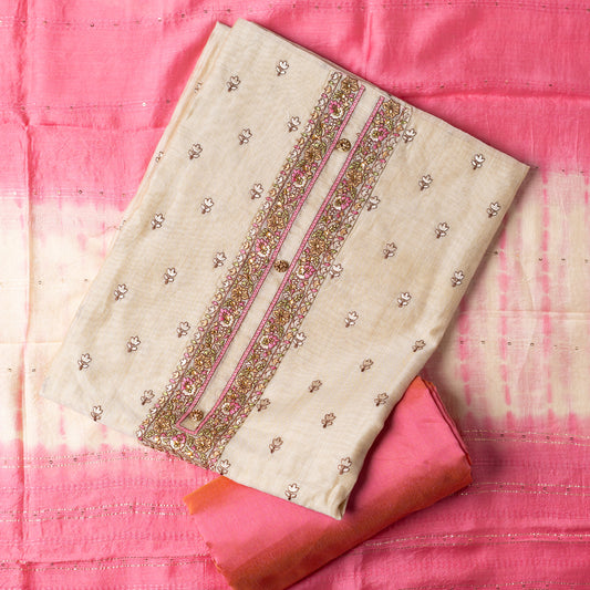 unstitched chanderi silk dress material set, Ivory color Chanderi Silk top with self color floral embroidery all over the body in the front and elegant pink color embroidery work in neck line with show buttons. cotton pink color plain bottom. Pink and cream color silk dupatta with sequins and thread work