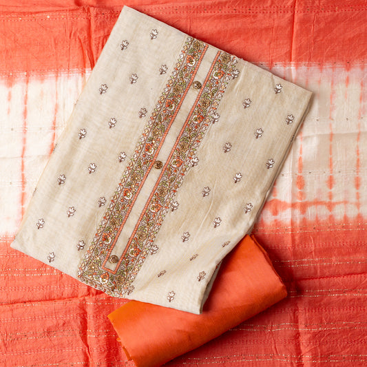 Chanderi silk unstitched dress material set, Ivory color Chanderi Silk top with floral embroidery all over the body in the front and elegant peach color embroidery work in neck line with show buttons. cotton peach color plain bottom. Peach and cream color silk dupatta with sequins and thread