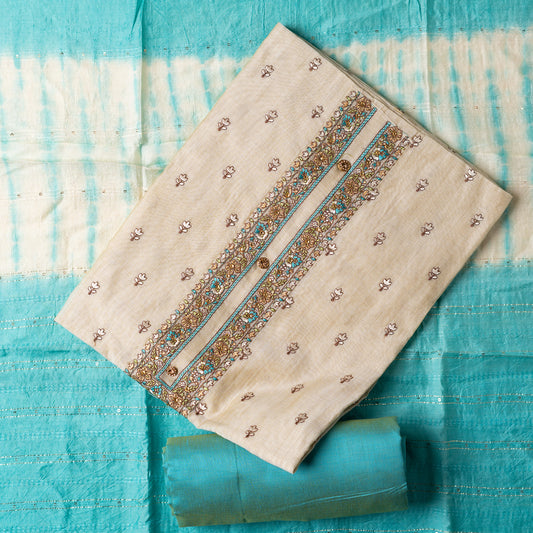 churidhar material set, Ivory color Chanderi Silk top with floral embroidery all over the body in the front and elegant sea green color embroidery work in neck line with show buttons. cotton sea green color plain bottom. Sea green and cream color silk dupatta with sequins and thread work