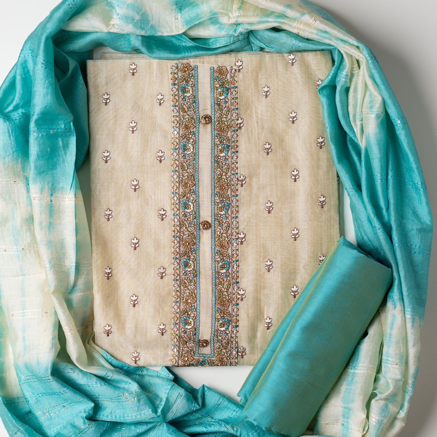 churidhar material set, Ivory color Chanderi Silk top with floral embroidery all over the body in the front and elegant sea green color embroidery work in neck line with show buttons. cotton sea green color plain bottom. Sea green and cream color silk dupatta with sequins and thread work