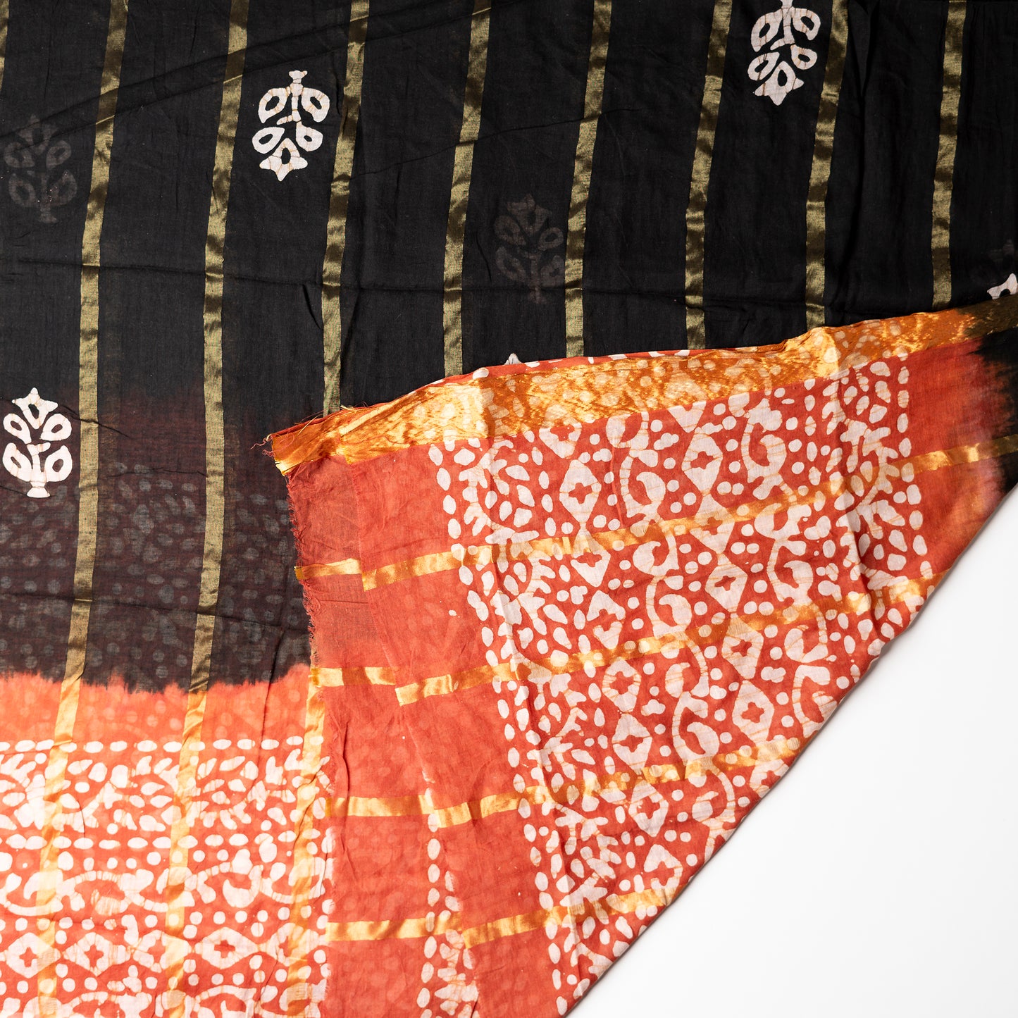 Cotton dupatta with golden color lines and wax batik prints.