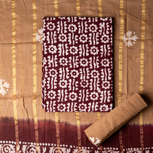 Brown color cotton wax batik printed dress material top, light brown color cotton bottom with prints. Cotton dupatta with golden color lines and wax batik prints.