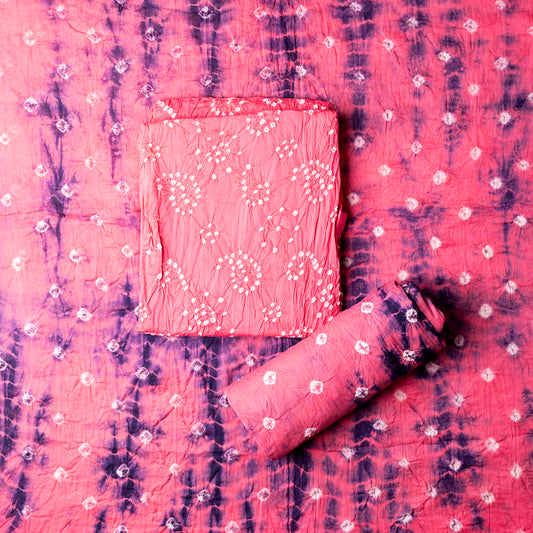Pink color top with white bandhej designs,  Pink color bottom with shibori designs in blue. Pink color dupatta with shibori designs in blue color and golden borders.