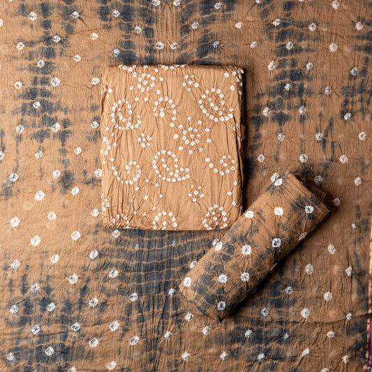 Cotton bandhani dress material, Brown color top with white bandhej designs,  Brown color bottom with shibori designs in black color.  Brown color dupatta with shibori designs in black color and golden borders.
