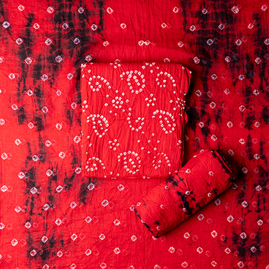 Cotton Bandhani Dress Material, Red color top with white bandhej designs,  red color bottom with shibori designs in black. Red color dupatta with shibori designs in black color and golden borders.