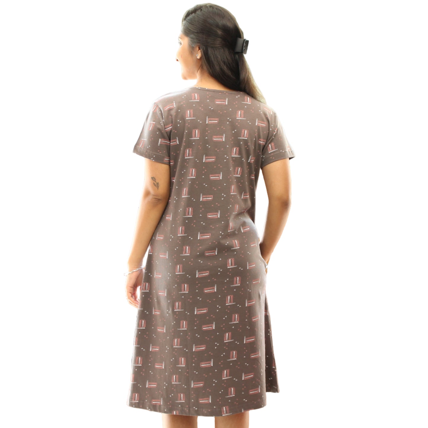 women standing showing the backside view of grey color short nighty with prints all over