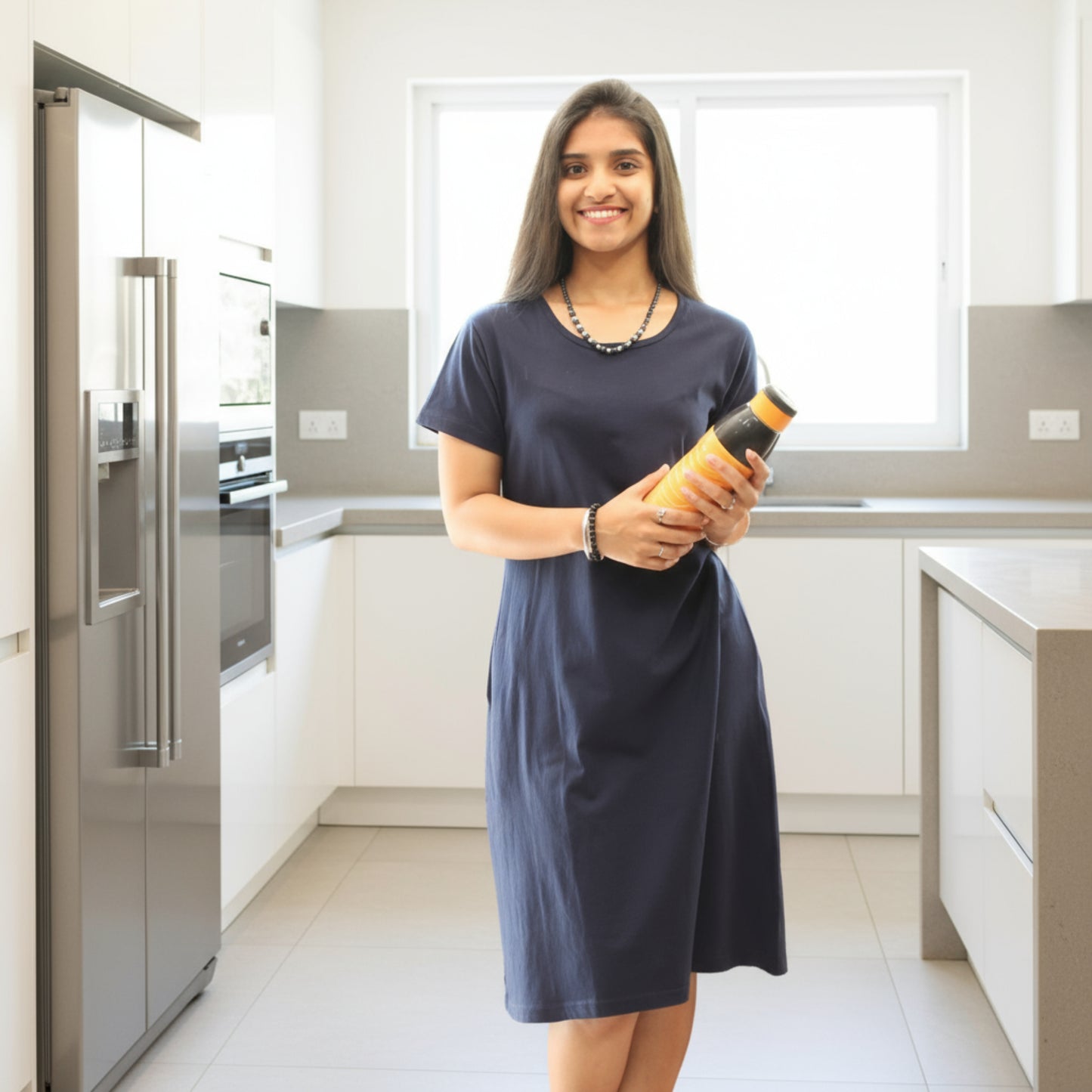 women holding a water bottle, wearing navy blue cotton t shirt dress