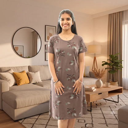 Women wearing knee length short nighty with pocket, color is brown and it has print all over with leaf design