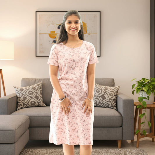 Women wearing cotton knee length short nighty in light pink color with prints all over 