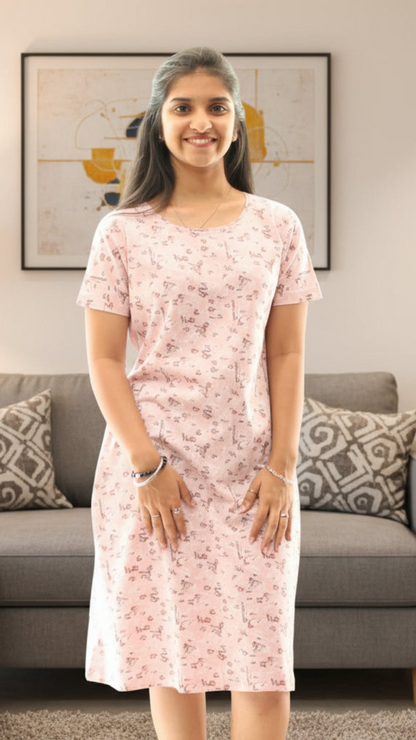 Woman wearing a pink floral dress standing in a living room.