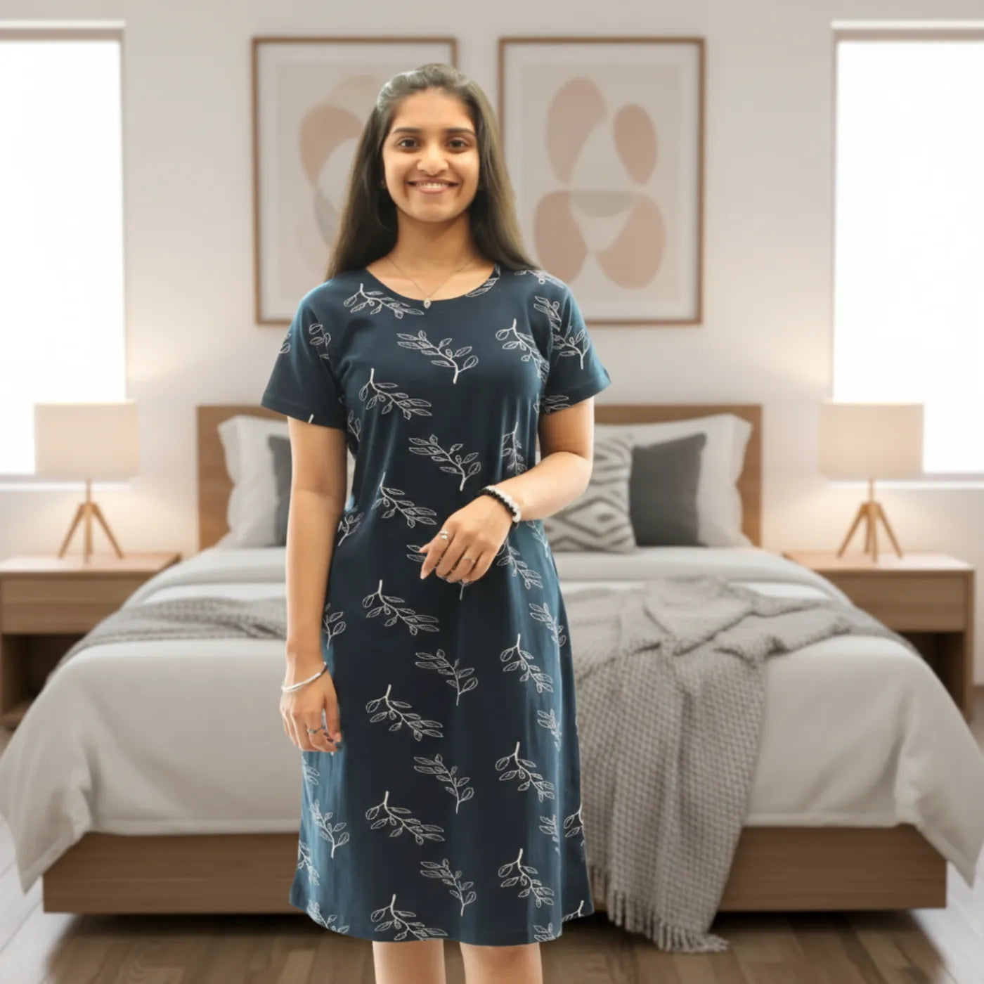 women wearing navy blue cotton knee length short nighty with all over leaves design printed in white color 