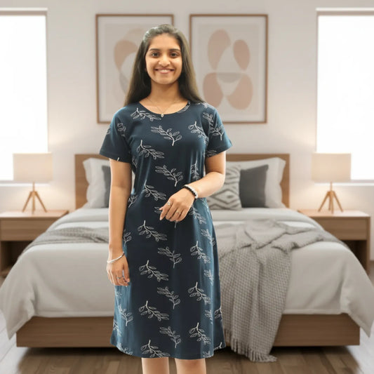 women wearing navy blue cotton knee length short nighty with all over leaves design printed in white color 