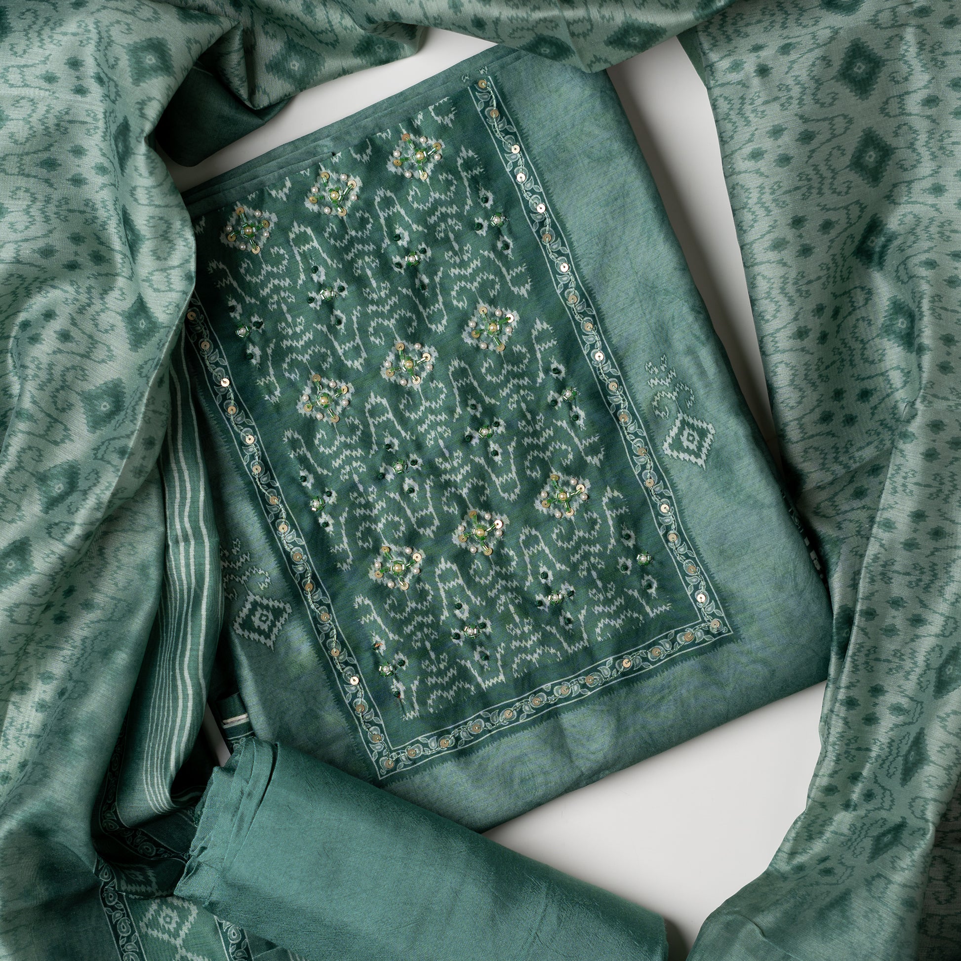 office wear teal color unstitched churidar set with patola print and stone work