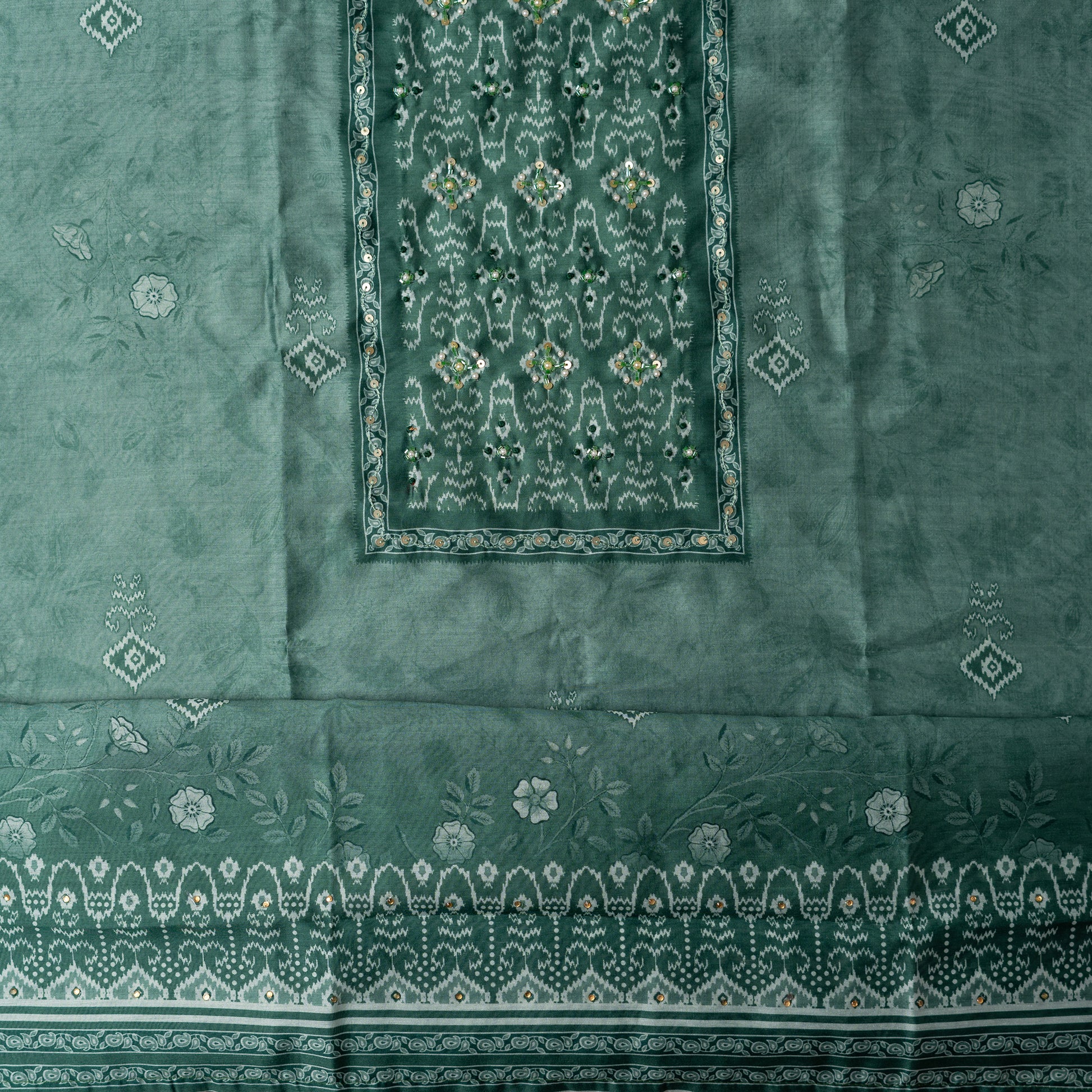 pastel teal color top in silk with floral and patola print all over along with stone work on the yoke