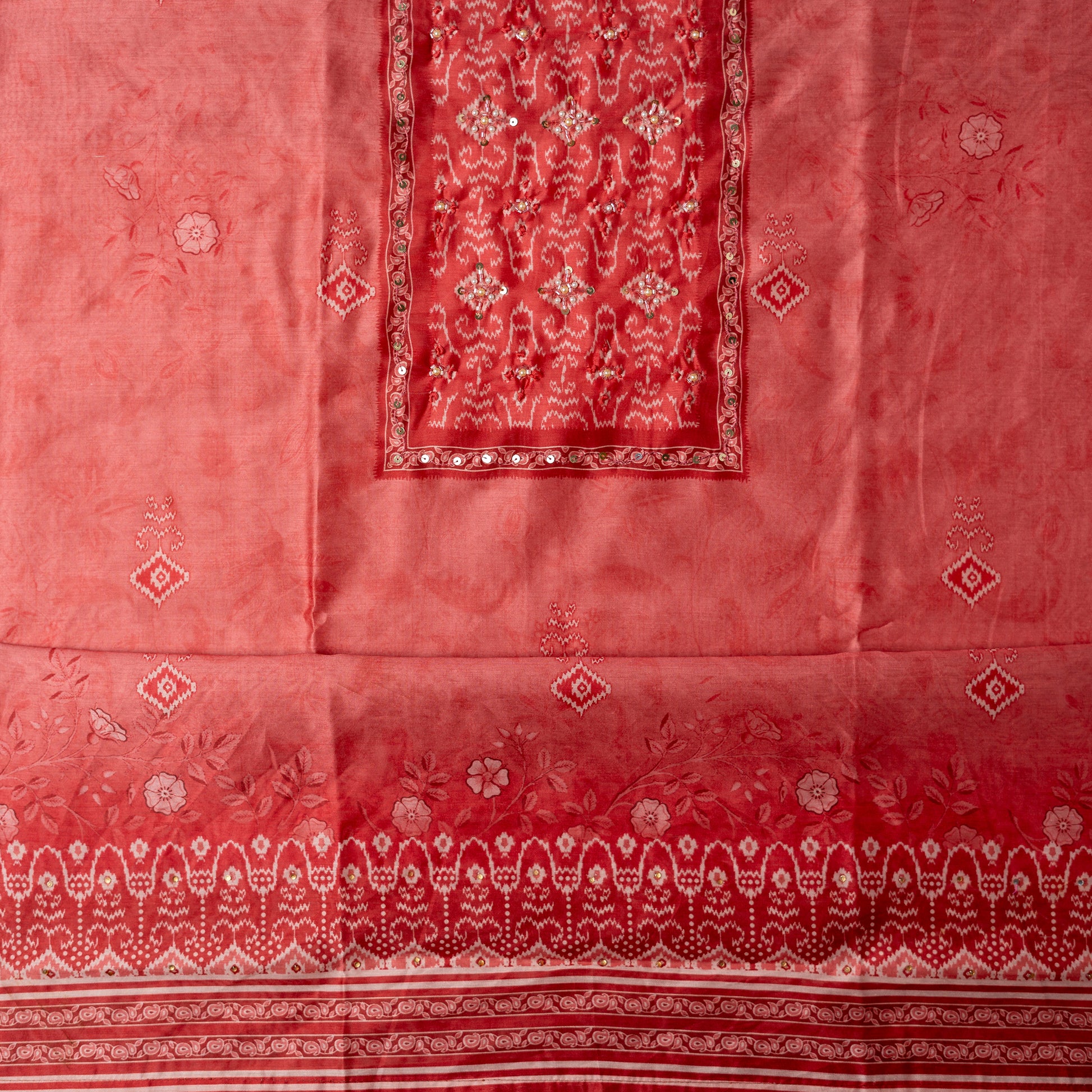 coral pink color silk top with floral and patola prints along with stone work on the yoke