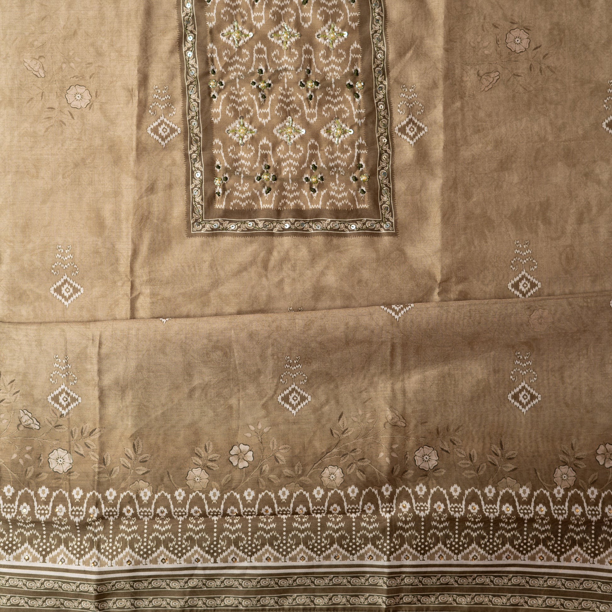 pastel green color top in silk with floral and patola print all over along with stone work on the yoke