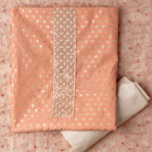 peach color silk dress material with golden butti work and embroidery on the yoke