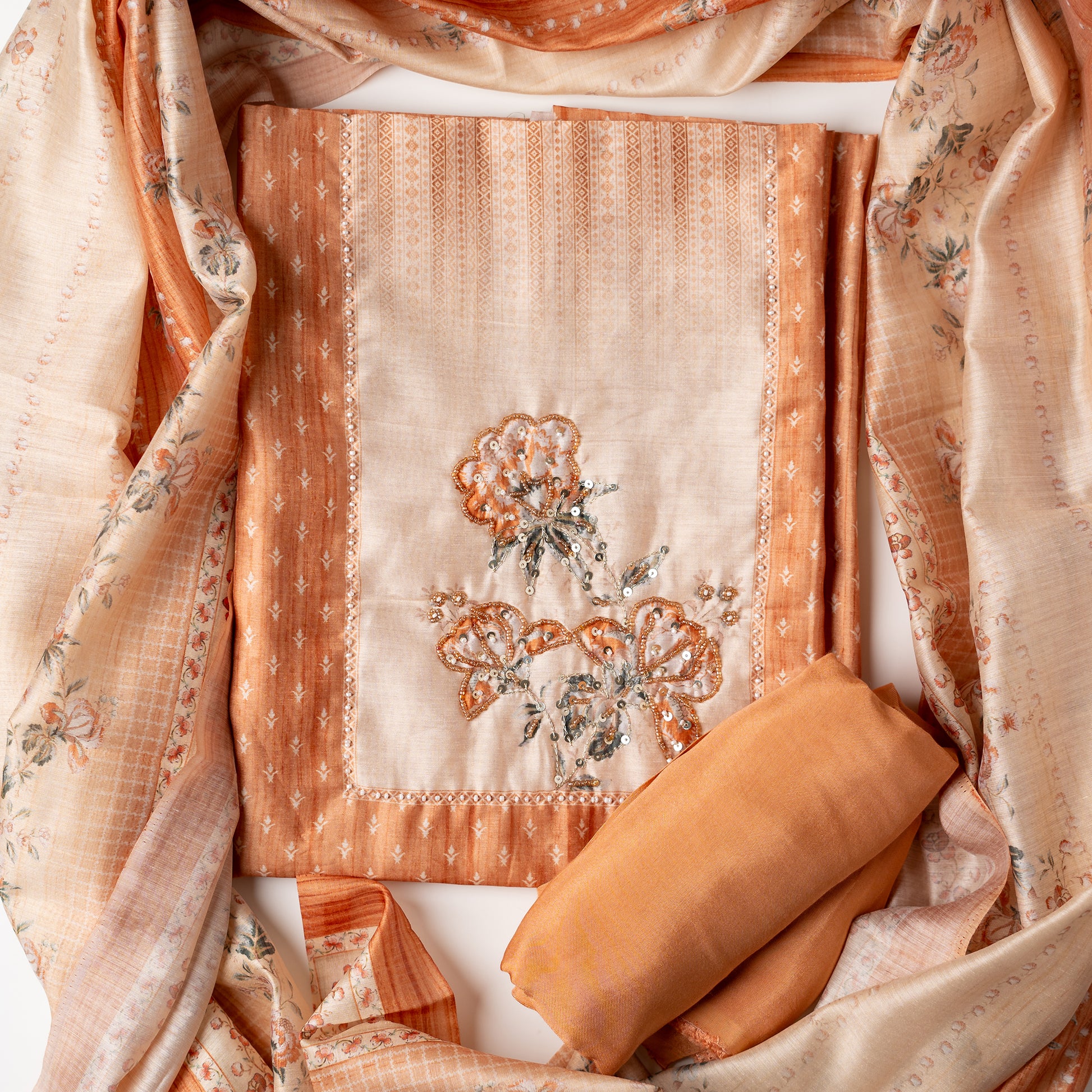 This beautiful chanderi silk unstitched salwar suit is perfect for any occasion, your office wear or party wear. Light orange color chanderi silk top with elegant digital prints all over the body. it has sequins and bead work in neck line area. Cream color dupatta with digital print designs. Cotton silk light orange color bottom .