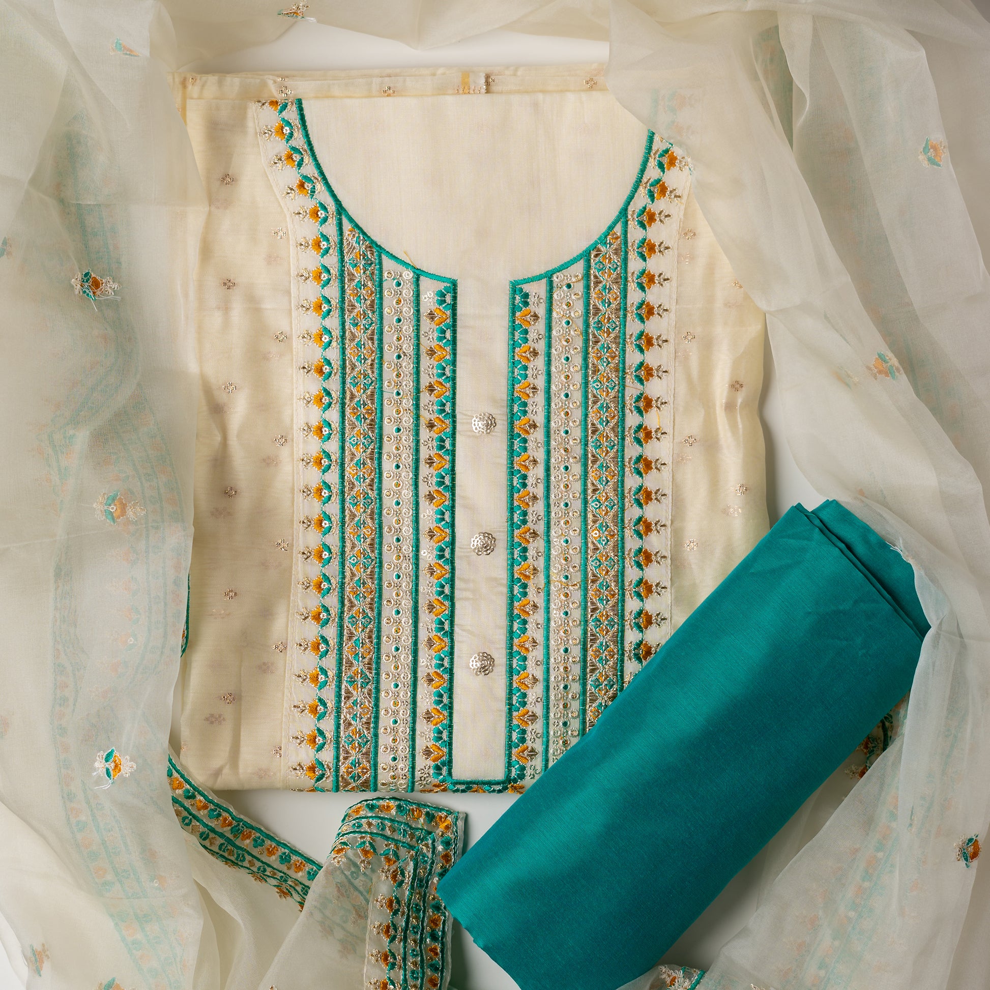 A unique design , perfect for your loved ones . Gift this beautifully embroidered chanderi silk unstitched salwar suit material. Top with embroidery work on neck line and golden thread jacquard small design weaving all over. The border of the dress is also embroidered elegantly. Matching cream color dupatta with embroidery work all over and on the borders. Green color cotton silk bottom. 