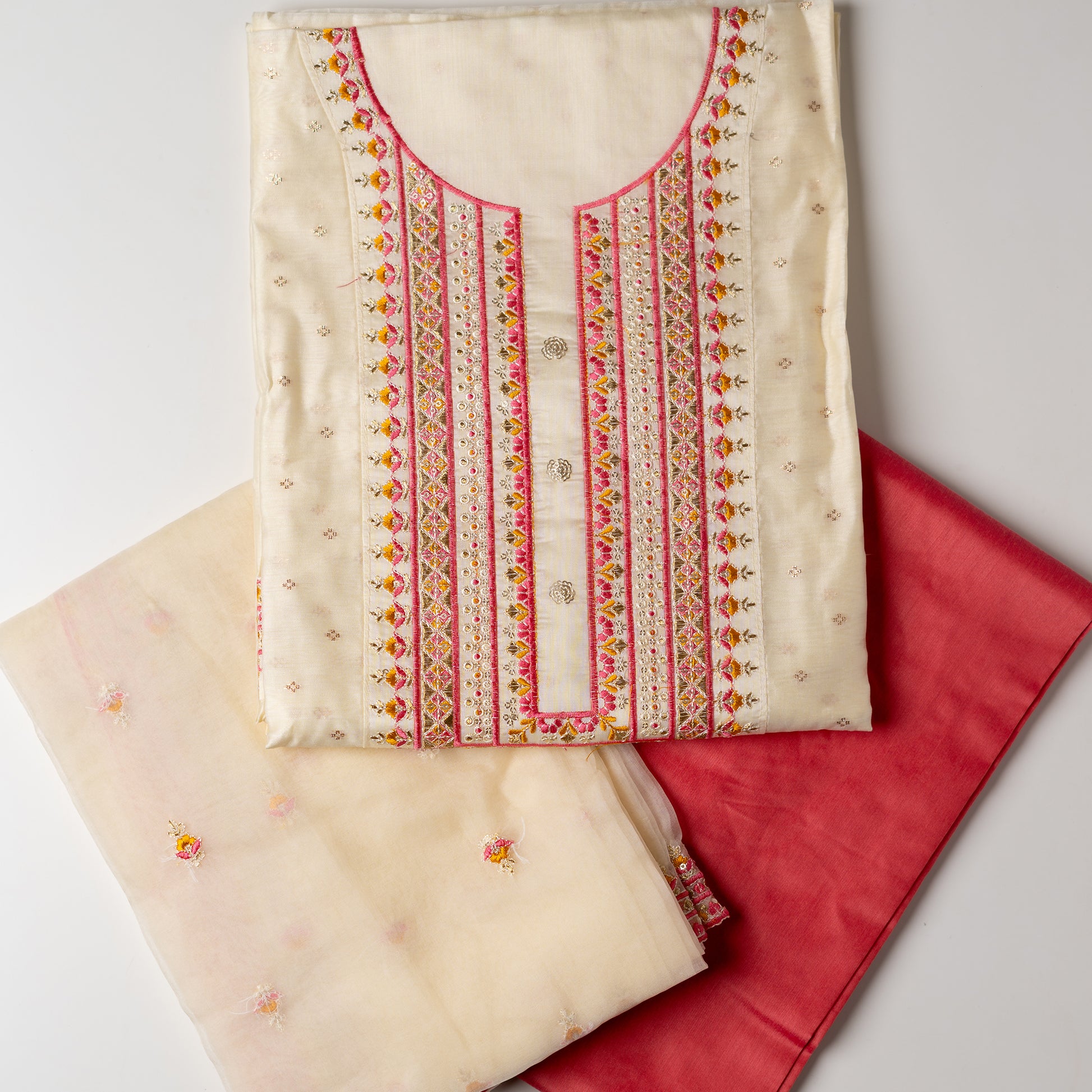 A unique design , perfect for your loved ones . Gift this beautifully embroidered chanderi silk unstitched salwar suit material. Top with embroidery work on neck line and golden thread jacquard small design weaving all over. The border of the dress is also embroidered elegantly. Matching cream color dupatta with embroidery work all over and on the borders. Peach color cotton silk bottom.